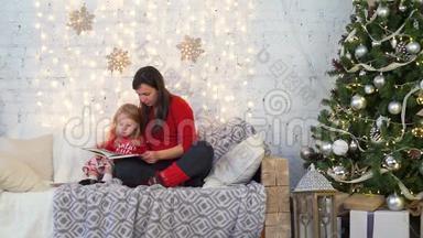母亲和女儿在圣诞节读一本书